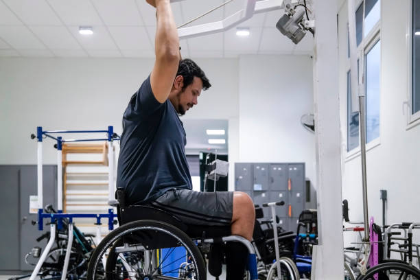 istock Man in wheelchair at physiotherapy 1431481579