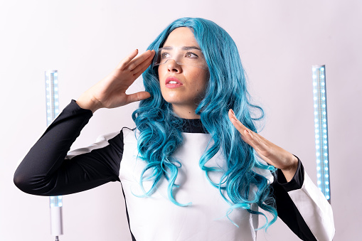 Futuristic, portrait of a young woman with blue hair, wearing augmented reality glasses