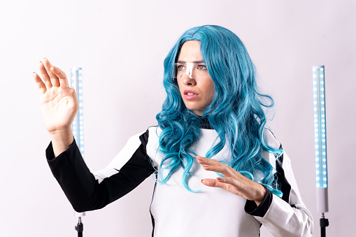 Futuristic, portrait of a young woman with blue hair, wearing augmented reality glasses looking to the left