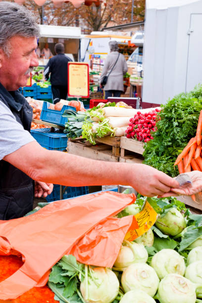 istock Customer pays for purchase at a greengrocer 1431487695