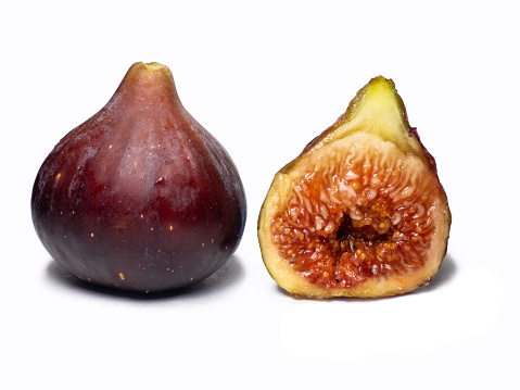 Ripe figs on a white background.   Southern fruit isolate. Sliced purple fruit. Healthy diet. For diet