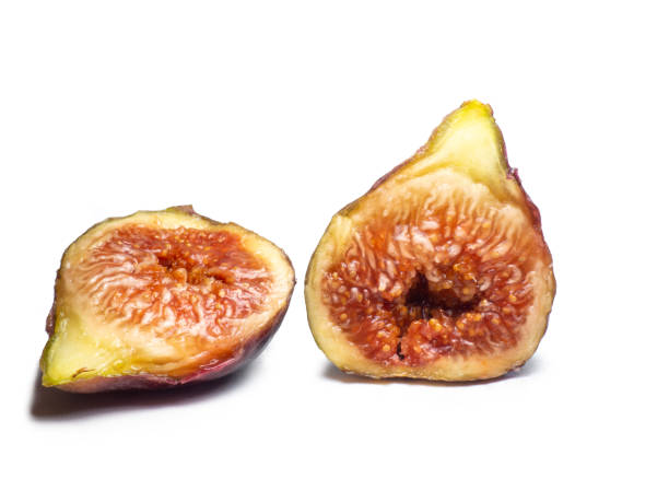 istock Ripe figs on a white background. Southern fruit isolate. Sliced purple fruit. Healthy diet. 1431498274