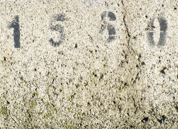 istock Background of porous concrete. Numbers on concrete. Gray wall. Solid background. 1431500261