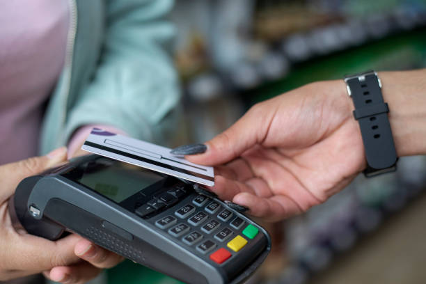 istock non-binary person paying with a contactless card at a supermarket 1431502956