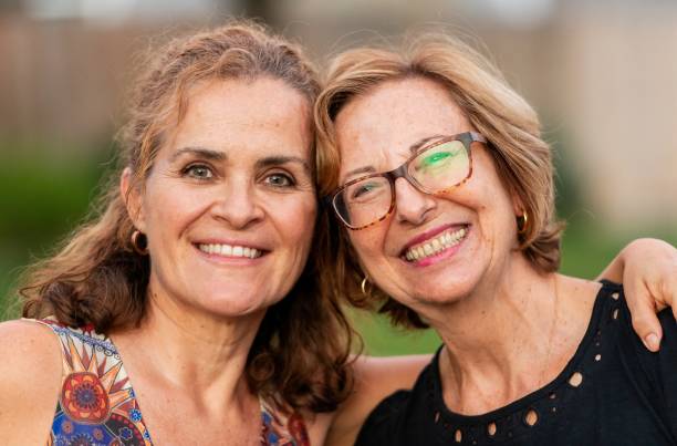 istock Smiling happy Mature lesbian couple posing looking at the camera 1431503729