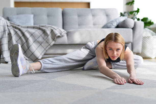 istock Woman doing stretching exercise at home 1431512980
