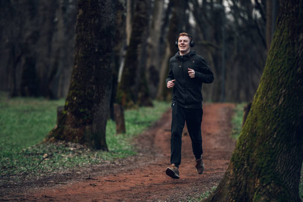 istock Young redhead man running in forest 1431513829