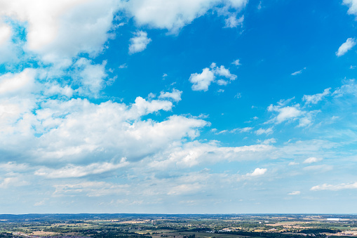 Fluffy clouds and clear blue sky background in summer