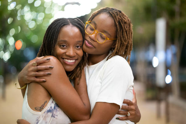 istock Twin sisters hugging outdoors 1431533289
