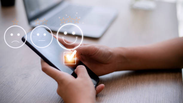 istock Customer service evaluation concept. using a smartphone is pressing face emoticon smiling in satisfaction on virtual touch screen. 1431548793