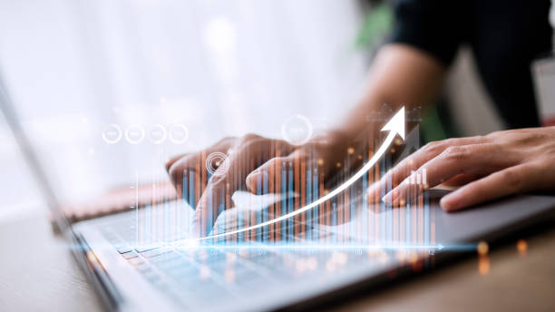 istock people using tablets And using his finger to touch the screen With a business graph showing up in a virtual screen.New startup ideas and business growth concept. 1431548925