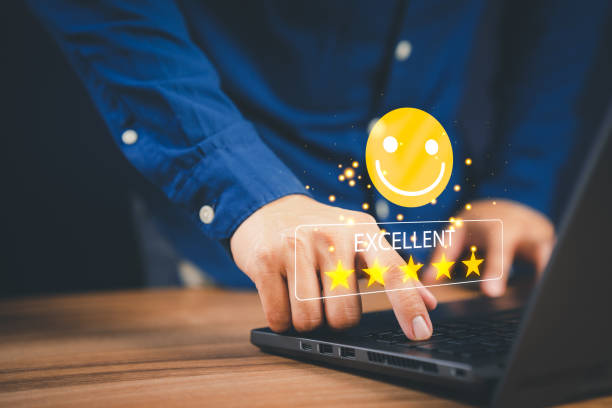 istock Man hand using computer laptop with popup five star icon for feedback review satisfaction service, testimonial. Customer service experience and business satisfaction survey. 1431549030