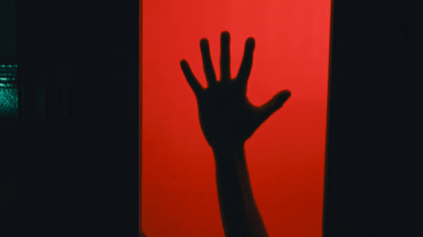 istock Arm With Knife Behind A Glass Door 1431551482