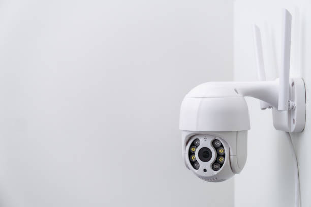 istock Round CCTV camera with antennas shoots video on the white wall 1431551734