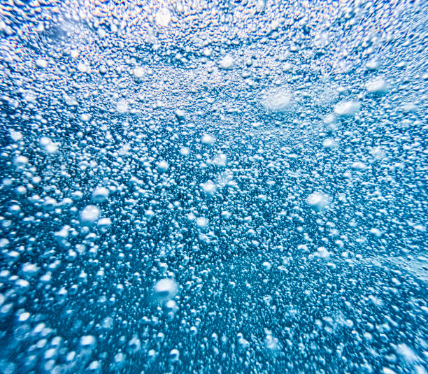 This is a abstract close up underwater photo of a spa jets for water massage with all the bubble coming directly towards the camera