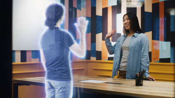 istock Asian girl talks on call with friend using augmented reality software VFX holographic effect 1431555743