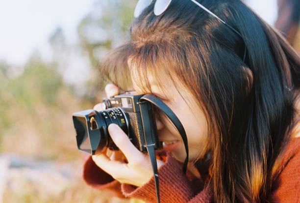 istock A young girl is holding a camera during a hiking trip 1431555754