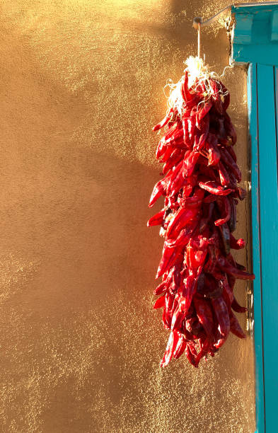 istock Santa Fe, NM: Sunlit Chili Pepper Ristra, Adobe Wall, Blue Door 1431558586