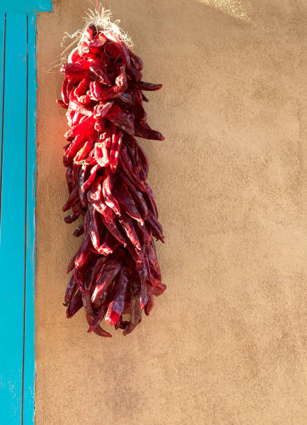istock Santa Fe, NM: Sunlit Chili Pepper Ristra, Adobe Wall, Blue Door 1431558605