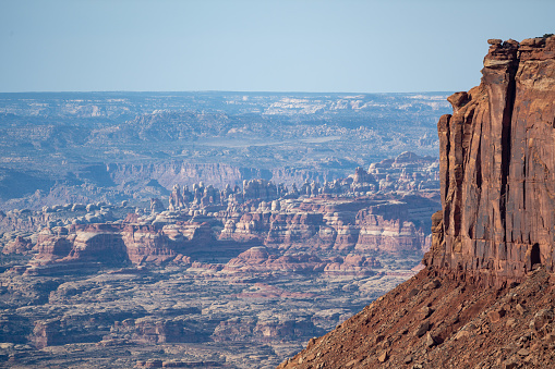 Aerial view overlooking The Maze containing deep canyons, plain deserts and mountain ranges in Canyonlands National Park, Utah, USA.