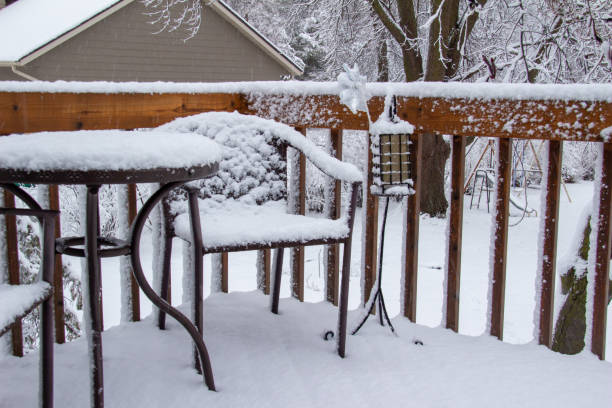 istock View of an outdoor deck with table and chairs, covered with snow 1431574896