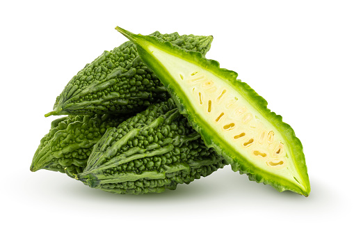 Fresh bitter gourd Bitter cucumber or bitter melon with cut slice isolated on a white background.