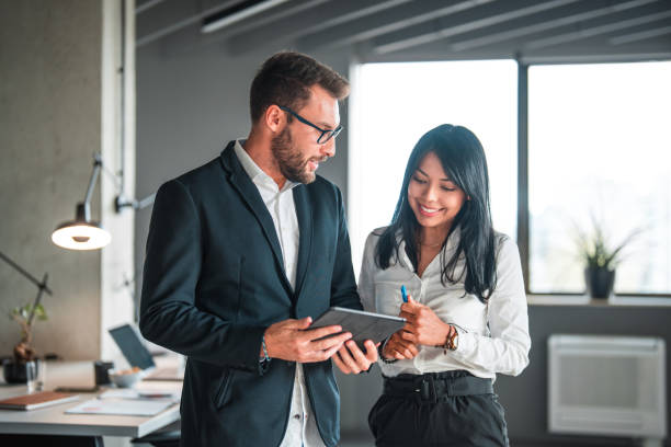 istock Attractive Hispanic Female Manager Working With A Young Male Business Developer 1431581233