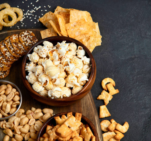 istock Assortment of salty snacks on dark background. 1431581441