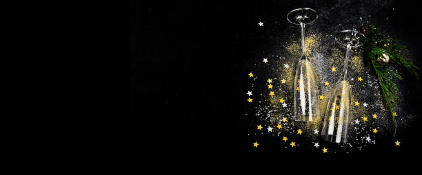 istock Two glasses of champagne with glitter and splash. Celebration theme. 1431581459