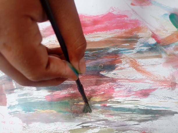 istock A boy is painting on paper 1431583125