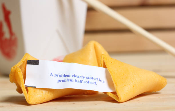 Fortune Cookie With Message. A problem Clearly Stated is a Problem Half Solved stock photo
