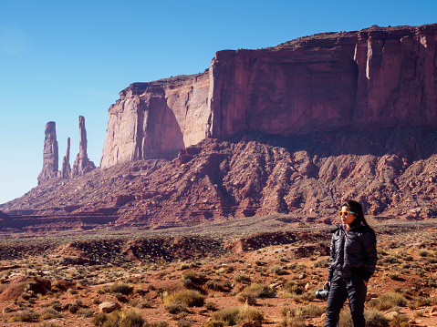Woman tourist enjoying beautiful scenery of Monument valley, Utah, USA