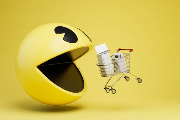 a yellow emoji with an open mouth eats a cart with household appliances. 3D render a yellow emoji with an open mouth eats a cart with household appliances. 3D render. fiera stock pictures, royalty-free photos & images