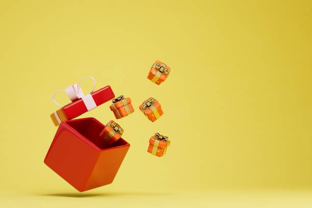 istock a large gift box from which small boxes with gifts on a yellow background fly out. copy paste, copy space. 3D render 1431595746