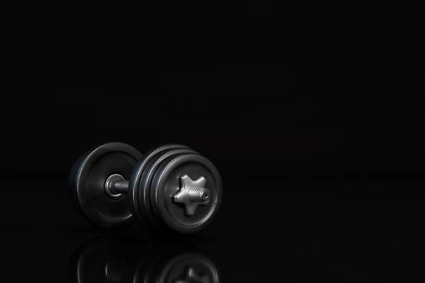 istock strength exercises with a barbell. the barbell is black on a black background. copy paste, copy space. 3D render 1431595768