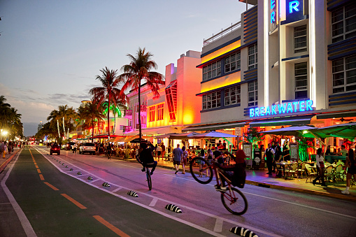 Colorful art deco buildings lit up along Ocean Drive, South Beach, Miami.