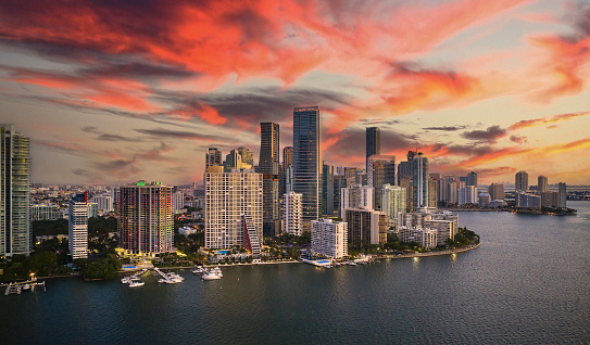 Aerial view above Biscayne Bay of Brickell Key, marina, and downtown district in background.