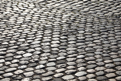 background of road pavement made with many smooth pebbles without people