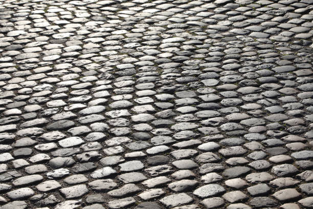 road pavement made with many smooth pebbles without people background of road pavement made with many smooth pebbles without people liege belgium stock pictures, royalty-free photos & images