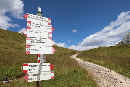 sign with many arrows to reach the mountain resorts with the names of the places in Italian