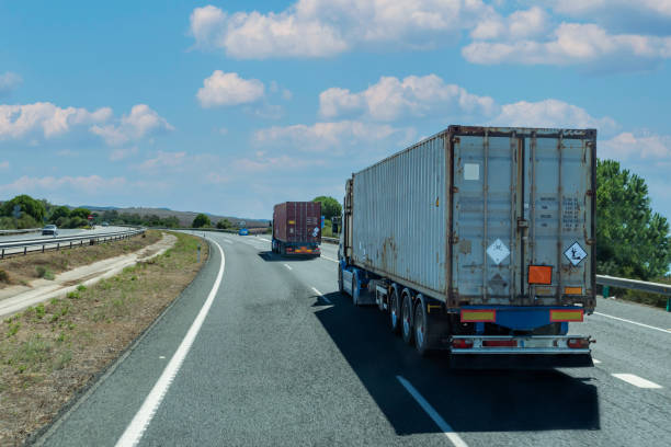 istock Trucks circulating with containers marked with orange panels, transport under ADR, with danger labels for toxic and polluting products. 1431607305