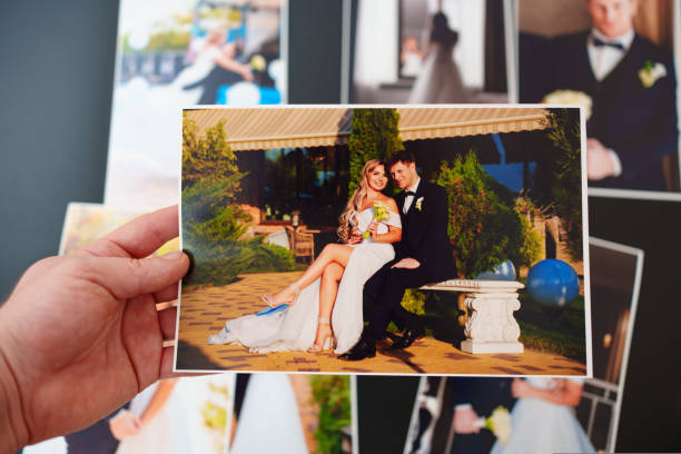 istock printed wedding photos on a black background and in hand. 1431609885