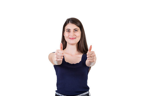Positive young women with cheerful looking to camera, keeps both thumbs up isolated on white background with copy space. Girl showing approval gesture, liking sign