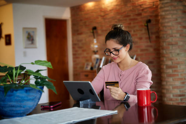 istock Hispanic young woman shopping online using digital tablet at home with copy space 1431614344