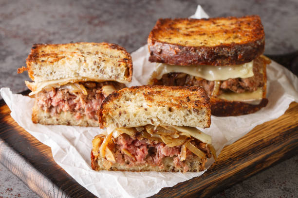 istock patty melt sandwich is a variant of the classic American cheeseburger using crispy bread, cheese, and tender onions closeup on the wooden board. Horizontal 1431615727