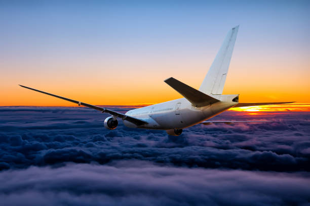 istock White wide body passenger airliner is flying in the sunset sky 1431621507