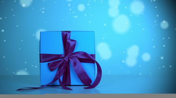 istock wrapped gift. close-up. light blue gift box with dark blue ribbon. light blue bokeh background with a slight shimmer. 1431624772