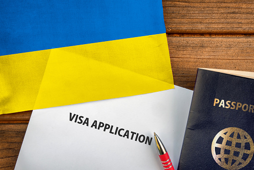 Visa application form, passport and flag of Ukraine