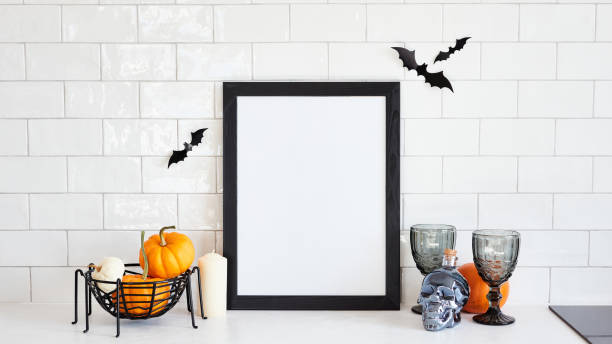 istock Picture frame mockup with pumpkins, skull, wine glasses, bats on table on brick wall background. Happy Halloween holiday concept. 1431633085