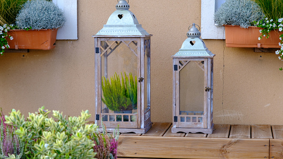 Beautiful wooden lanterns. decorative plants inside. on a wooden surface.